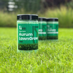 Aurum LawnGrow tirpių NPK trąšų pakuotė stovi žalioje vejoje.